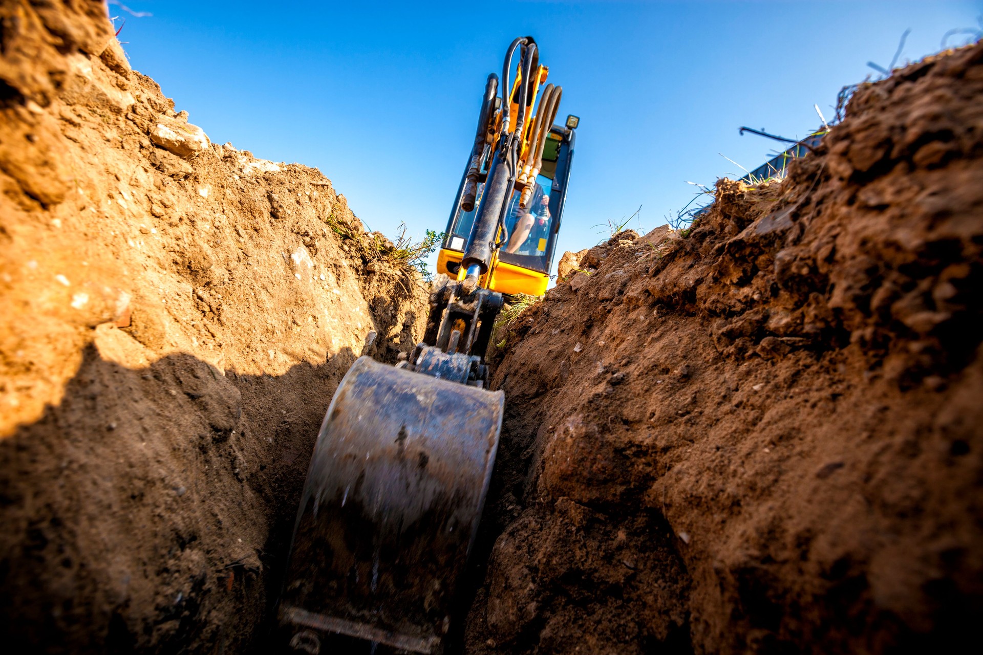 Excavator digs the foundation for the house